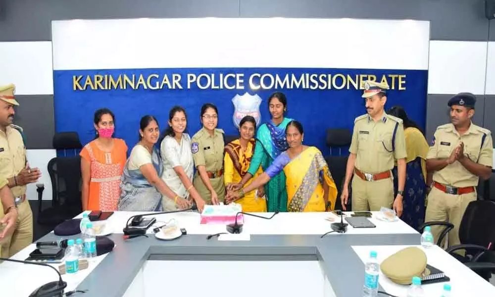Women police personnel celebrating International Womens Day by cutting a cake in Karimnagar on Monday