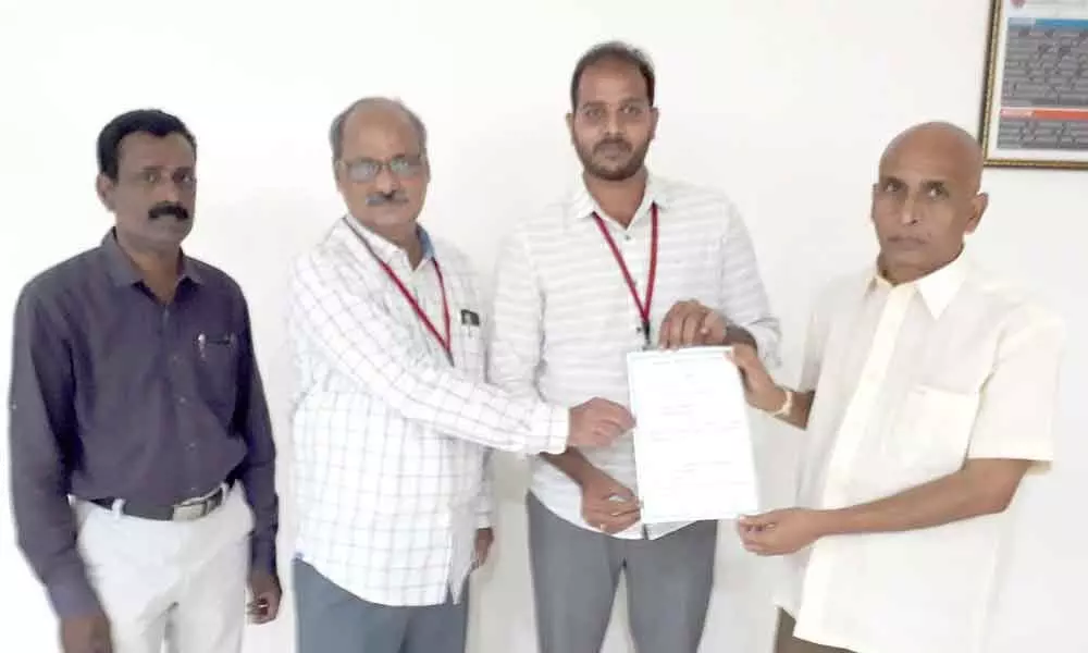 SRKR Engineering College secretary and correspondent Sagi Vithal Rangaru, principal Dr MJagapatiraju congratulating M Srihari Varma after he was awarded PhD by Acharya Nagarjuna University, in Bhimavaram  on Tuesday