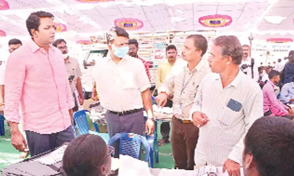 Chittoor district election observer Naveen Kumar  and Tirupati Municipal Commissioner  P S Girisha interacting with polling staff at  SV Arts College Ground in Tirupati on Tuesday