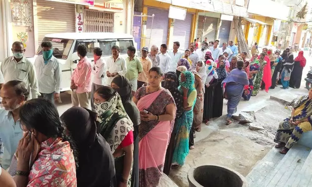 Voters standing in long queue in front of a polling station to exercise their franchise in Nandyal