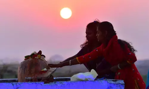 At the crack of dawn, devotees praying to Lord Siva on Maha Sivaratri, at Keesaragutta on Thursday. Photo: Adula Krishna