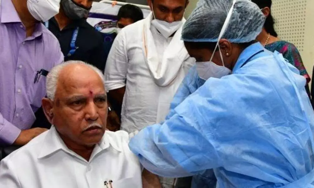 Chief Minister B.S. Yediyurappa getting their first dose of COVID-19 vaccine in Bengaluru on Friday