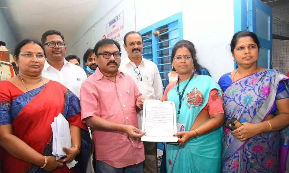 Gangada Sujatha receiving certificate of winning as YSRCP corporator from 18th division from Collector Dr Pola Bhaskara on Sunday