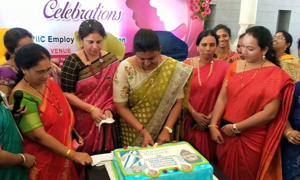 MLA and APIIC chairperson K Roja cutting a cake on the occasion of International Women