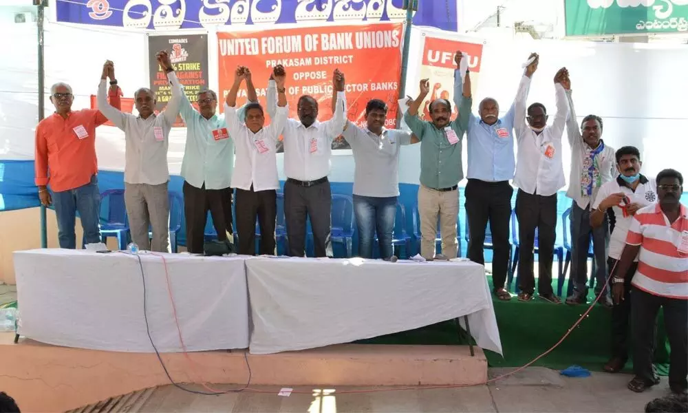 UFBU leaders protesting the privatisation of banks in front of Federal Bank in Ongole on Monday