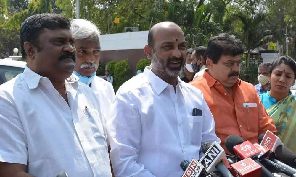 State BJP chief Bandi Sanjay Kumar along with MLC N Ramchander Rao and others addressing pressmen outside the Raj Bhavan after calling on the Governor Dr Tamilisai Soundararajan, on Monday