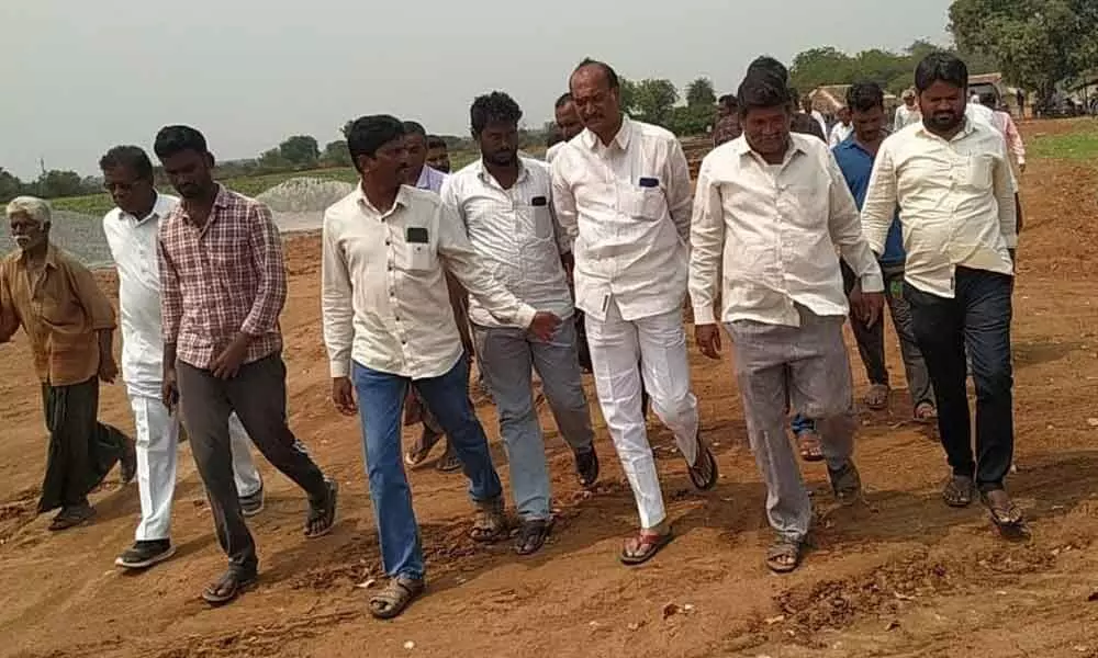 BJP Kisan Morcha State president K Sridhar Reddy along with leaders inspecting lands in Beerolu village on Tuesday