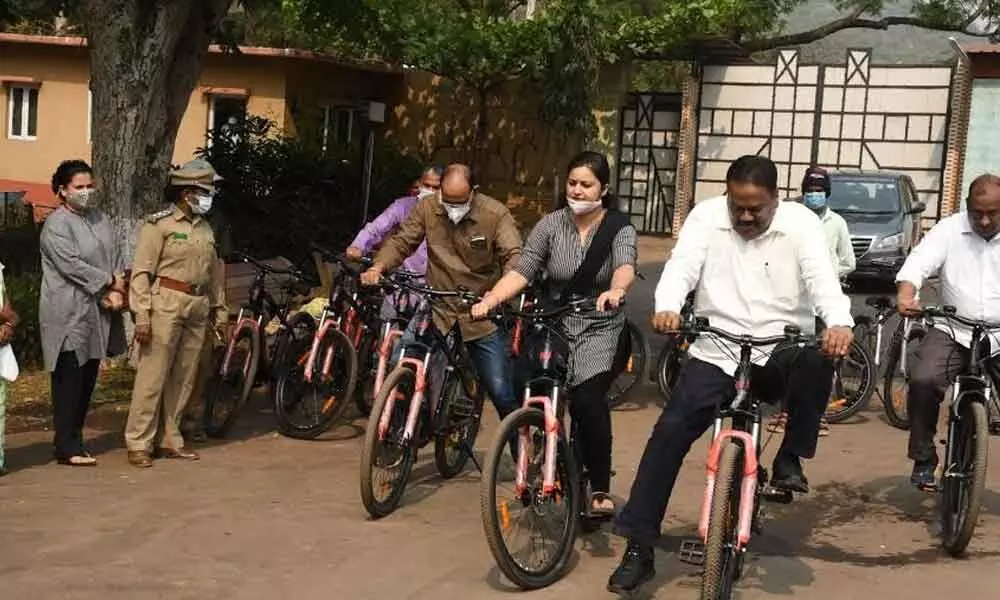 Indira Gandhi Zoological Park curator Nandani Salaria and Principal Chief Conservator of Forests, Andhra Pradesh N Prateep Kumar, among others launch 20 e-bikes for the visitors in Visakhapatnam on Tuesday