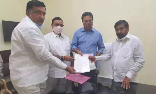 Karimnagar Dairy Chairman Ch Rajeshwara Rao and Mother Dairy Chairman Gutta Jitender Reddy submitting a representation to IT Minister KT Rama Rao and Energy Minister G Jagadish Reddy