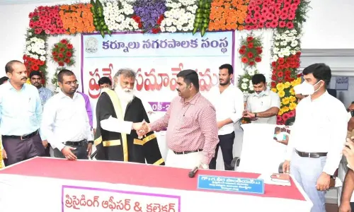 District Collector G Veera Pandiyan greeting the newly-elected Mayor B Y Ramaiah  at Municipal Council Hall in Kurnool on Thursday.