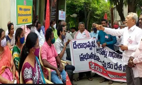 LIC staff staging demonstration in Vijayawada on Thursday