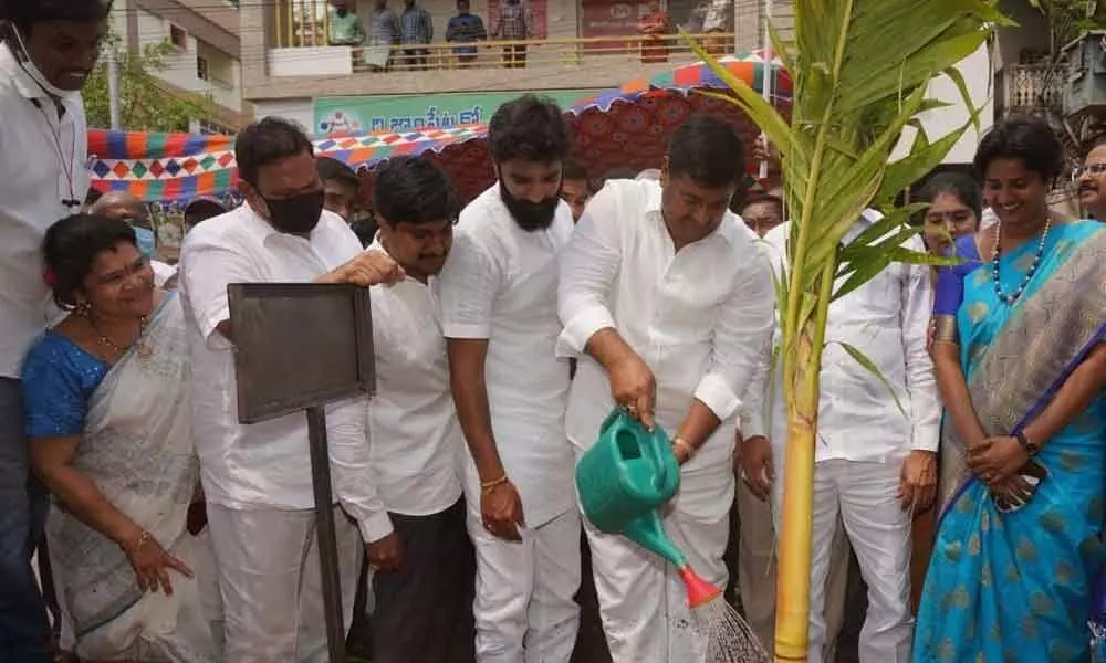 Deputy Chief Minister Dharmani Krishna Das and MP Bharat Ram watering a plant at VL Puram in Rajamahendravaram on Friday