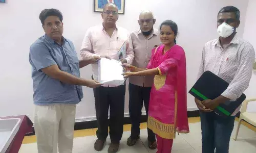 APSRTC Regional Manager T Chengal Reddy handing over the heavy vehicle driving licence to J Poornima in Tirupati