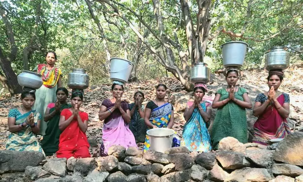 Carrying water container and kneeling down on the ground, women at   T Arjapuram village in Cheemalapadu Panchayat stage a protest to draw  the attention of the officials concerned
