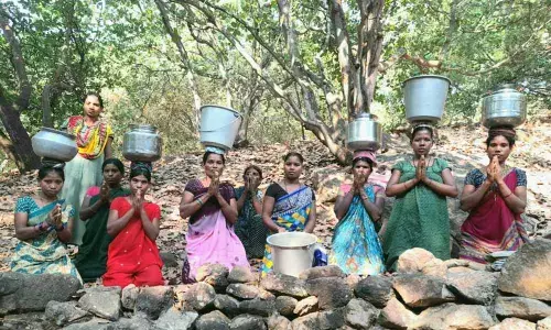 Carrying water container and kneeling down on the ground, women at   T Arjapuram village in Cheemalapadu Panchayat stage a protest to draw  the attention of the officials concerned