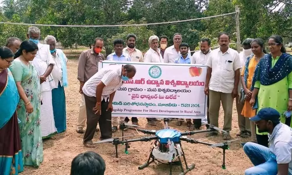 Scientists creating awareness on use of drones for spraying pesticides  in Nuzvid on Monday