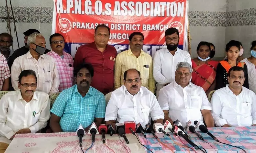 APNGOs Association president N Chandra Sekhar Reddy and general secretary Bandi Srinivasa Rao addressing a press meet in Ongole on Monday