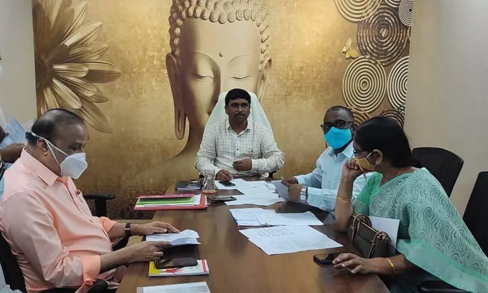 Joint Collector (Development) L Sivasankar reviewing the implementation of Aarogyasri with officials in Vijayawada on Monday