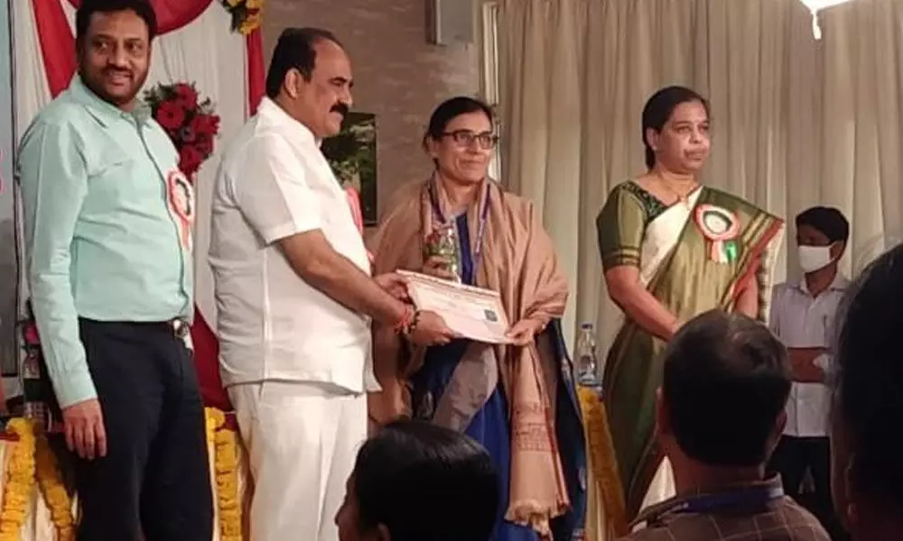 Prof P Uma Maheswari Devi receiving AP Scientist award from Minister Balineni Srinivasa Reddy in Vijayawada on Monday.