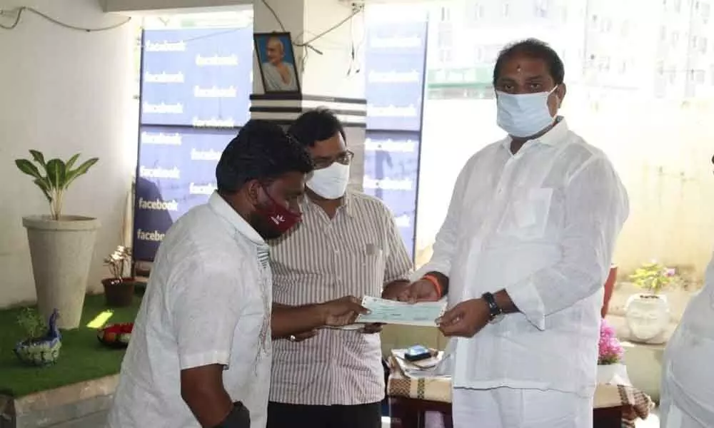 MLA Malladi Vishnu handing over CMRF cheque to beneficiaries in Vijayawada on Tuesday