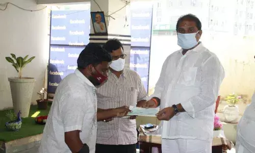 MLA Malladi Vishnu handing over CMRF cheque to beneficiaries in Vijayawada on Tuesday