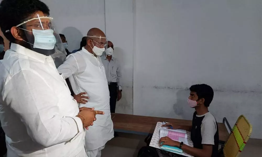 Minister CSVG Krishna interacting with a Covid-infected a student at Tirumala Junior College in Rajamahendravaram on Wednesday