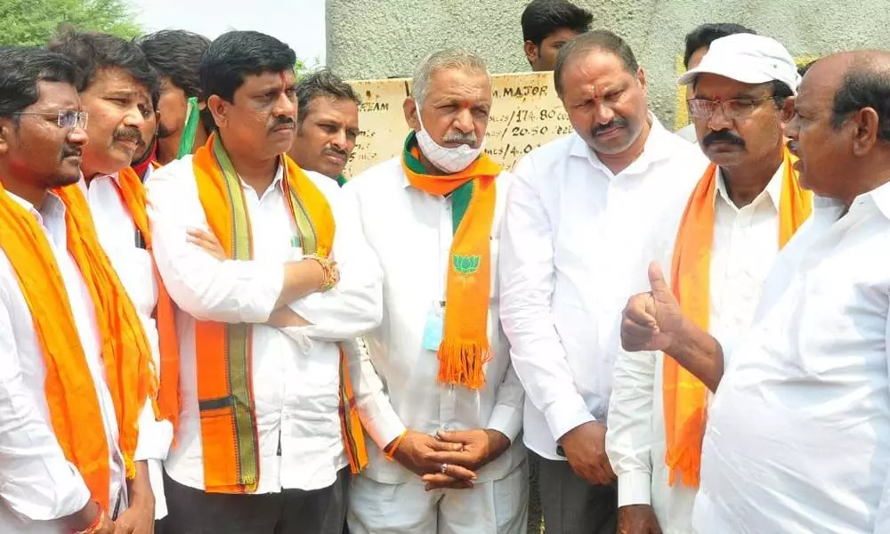 BJP district president Galla Satyanarayana interacting with farmers during padayatra in Thallada mandal on Thursday