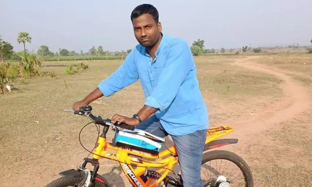 Raju with his battery-powered bicycle