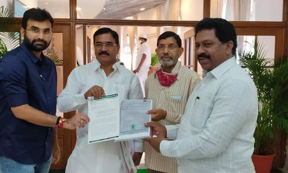 NDCCB Chairman P Bhaskar Reddy submitting a petition to Agriculture Minister Niranjan Reddy at the Assembly in Hyderabad on Friday. TCAB Chairman Konduri Ravinder Rao also seen