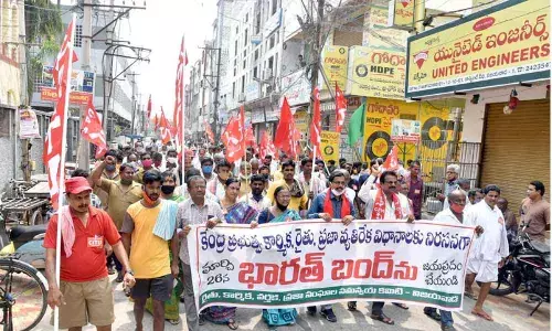 Leaders of all trade unions taking out protest rally as part of Bharat Bandh in One Town of Vijayawada on Friday