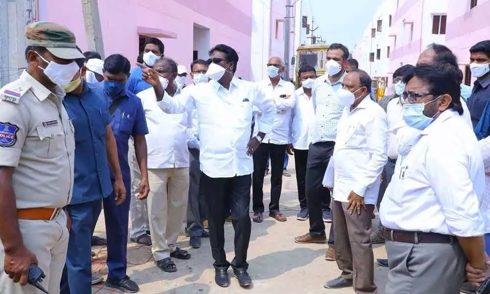 Transport Minister Puvvada Ajay Kumar along with Collector RV Karnan inspecting double bed room houses at Tekulapally on Saturday  in Khammam district