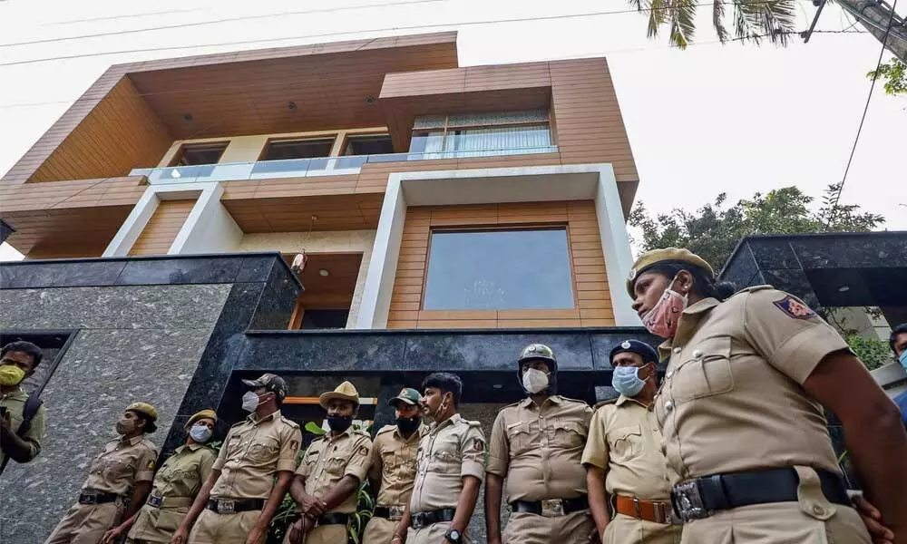 Police personnel outside BJP MLA Ramesh Jharkiholis residence during his press conference over the alleged allegations of sexual harassment against him, in Bengaluru, Saturday