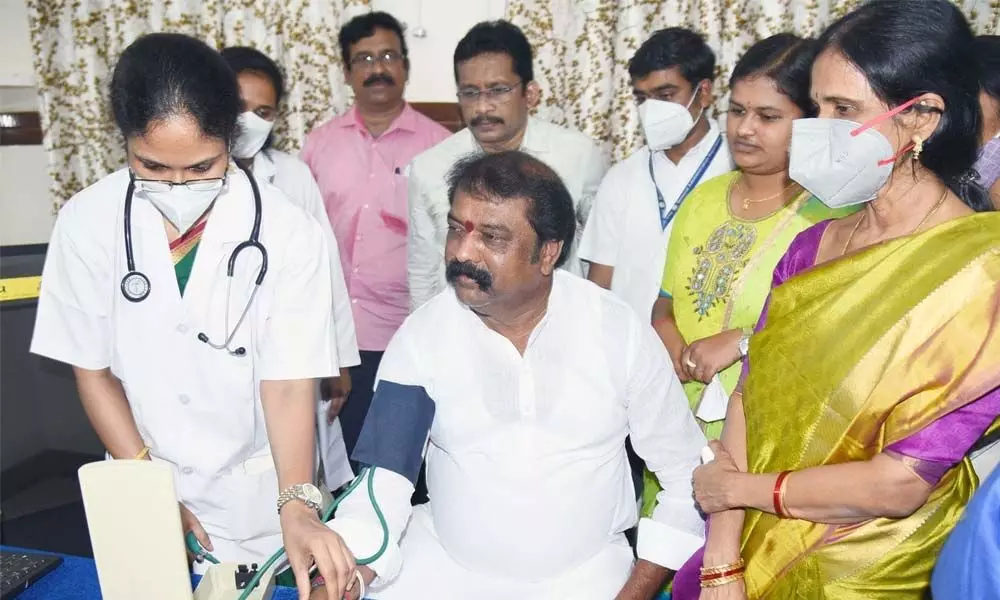 Labour Minister Gummanuru Jayaram getting his blood pressure checked after inaugurating ESI dispensary at Gunadala on Monday