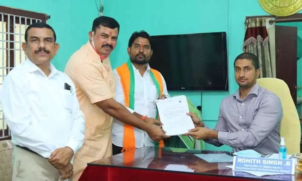 Along with MLA Raja Singh, BJP MLA candidate for Sagar byelection Dr Ravi Naik submitting his nomination papers to Election Returning Officer Rohit Singh at Nidamanoor