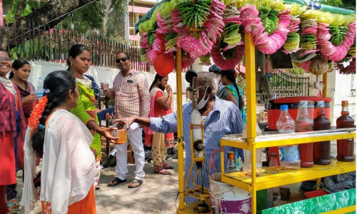A group of people savoring a cold drink for relief in the scorching sun at the Collectorate in Wednesday