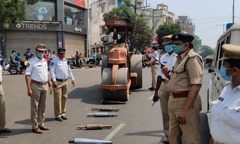 Police crushing bike silencers with road roller in Rajamahendravaram on Thursday