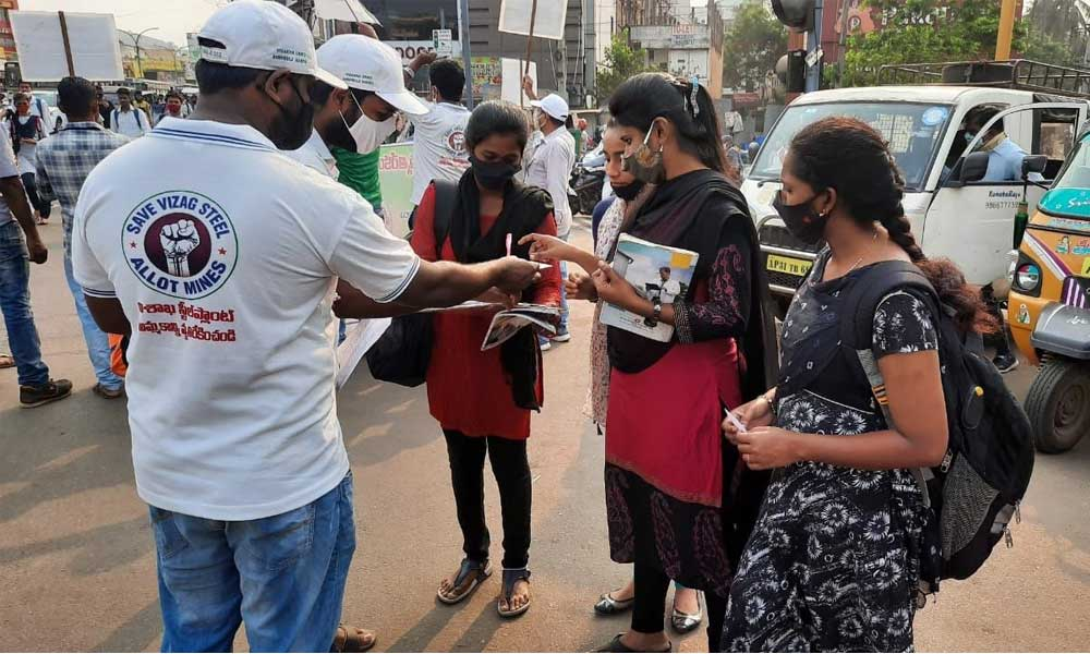 Employees from VSP distributing badges and collecting signatures from the students in Visakhapatnam on Thursday