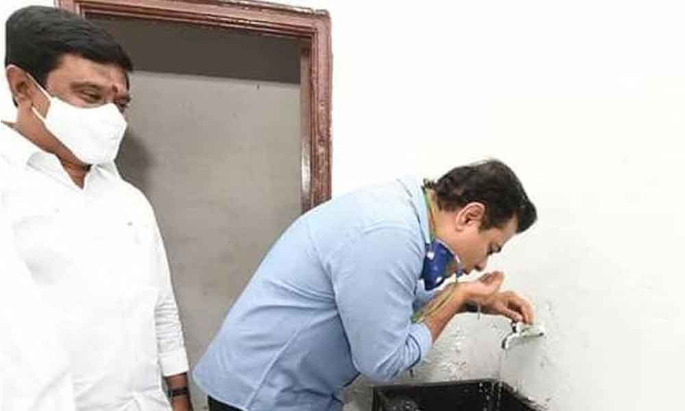 Minister KTR testing the drinking water in double bedroom houses at Tekulapally