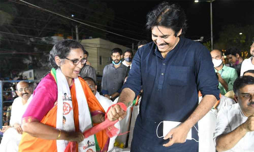 BJP-Jana Sena combine candidate K Ratna Prabha ties red cloth to Pawan Kalyan at the public meeting in Tirupati on Saturday