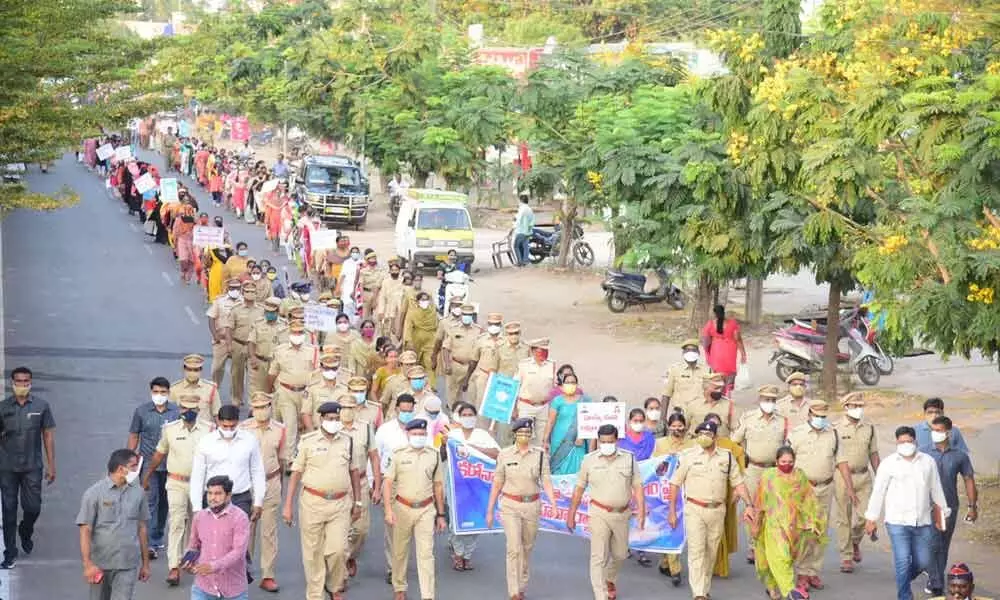 Police officials and local people taking part in a huge rally in Machilipatnam on Saturday