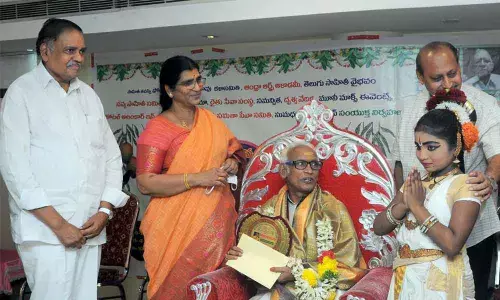 Andhra Pradesh Telugu Academy Chairperson N Lakshmi Parvathi and former Deputy Speaker Mandali Budha Prasad presenting Ugadi Puraskaram to Dr Vedantam Radhesyam in Vijayawada on Sunday