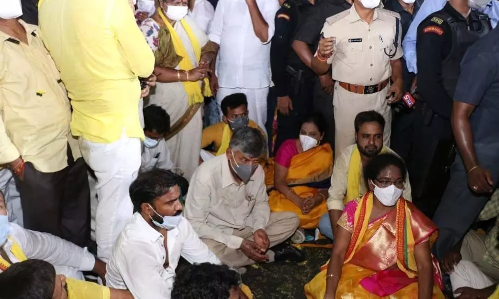 TDP chief  N Chandrababu Naidu stages a dharna on the road after stones were hurled at his vehicle during an election  rally in Tirupati on Monday