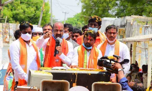BJP State president Bandi Sanjay Kumar along with party candidate Dr P Ravi Naik addressing the people during election campaign in Sagar constituency on Monday