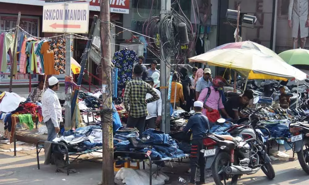 Vendors wait for customers ahead of festive season at Abids in Hyderabad. Photo: Srinivas Setty