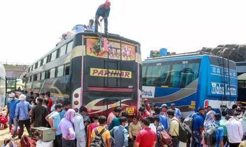 Migrant workers board buses to leave for their native places in Gurugram