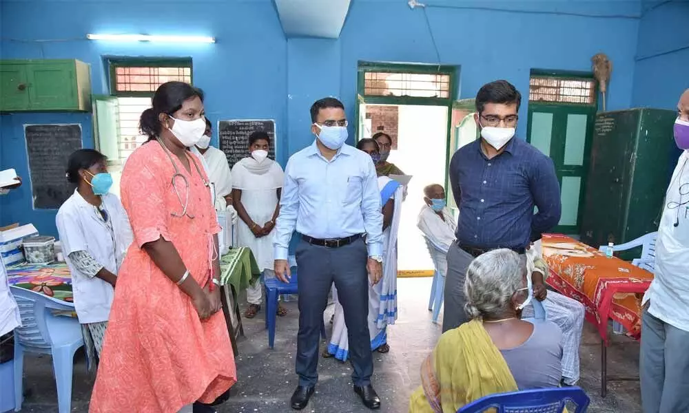 District collector Vivek Yadav, Tenali Sub-Collector Mayur Ashok interacting with an elderly people at vaccination centre in Mavillapadu on Wednesday