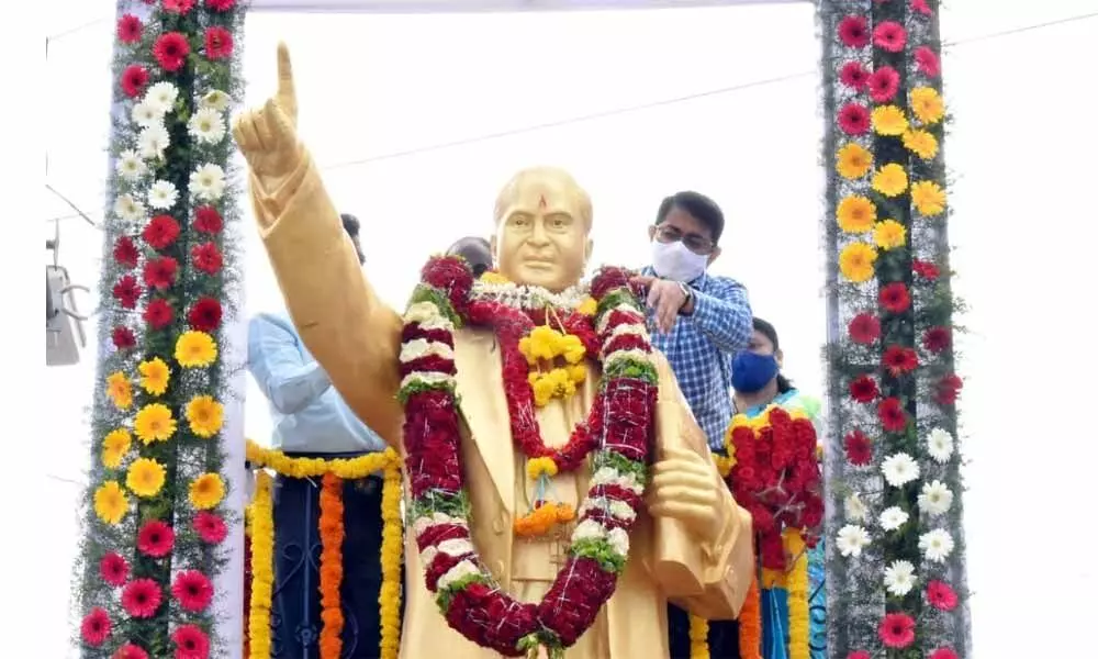 In-charge collector S Rama Sunder Reddy garlanding the statue of Dr B R Ambedkar at Old Bus Stand to mark his 130th birth anniversary, in Kurnool on Wednesday
