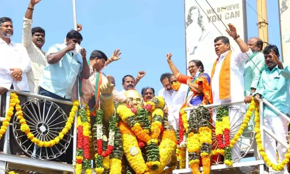 BJP candidate K Ratna Prabha paying rich tributes to the statue of B R Ambedkar near RTC Central Bus Station to mark his birth anniversary, in Tirupati on Wednesday