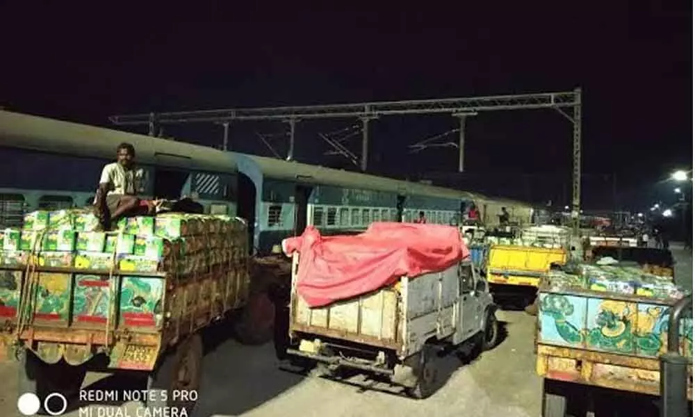 Boxes of mangoes being uploaded in special trains at Waltair division