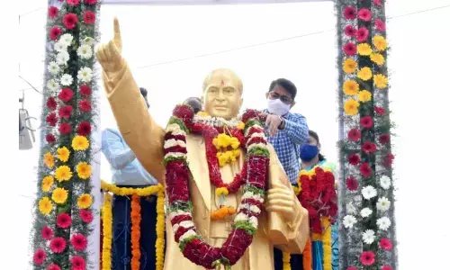 In-charge collector S Rama Sunder Reddy garlanding the statue of Dr B R Ambedkar at Old Bus Stand to mark his 130th birth anniversary, in Kurnool on Wednesday